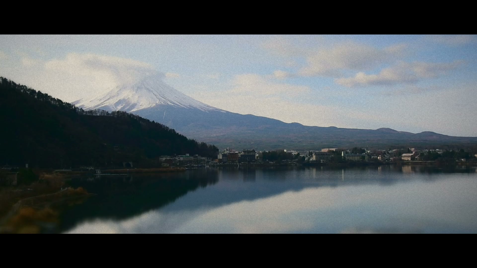 Mount Fuji reflected in a lake in the Japan travel film.