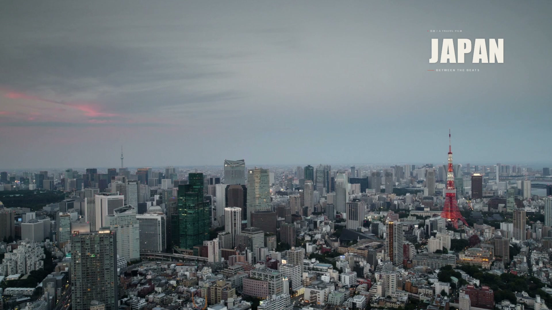 Tokyo skyline with the film title Japan: Between the Beats.